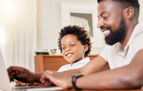 Home, kid and father with education on laptop for elearning, website or support in online class. Family, boy and man with technology by desk for virtual school, knowledge or help in child development. - Photo, image