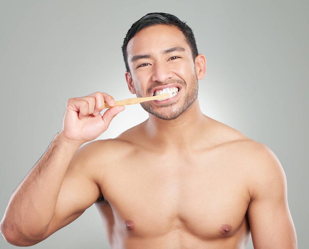 Dental, portrait and man with toothbrush in studio for oral hygiene, wellness or teeth whitening on white background. Mouth, body and hand of model for toothpaste, self care or morning routine. - Photo, Image