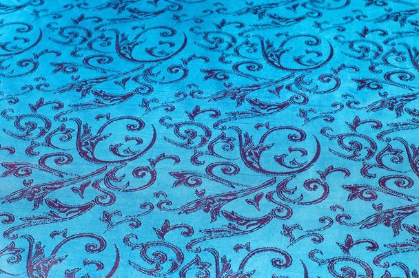 Fabric silk texture blue, flowers, abstract. a fine, strong, soft, lustrous fiber produced by silkworms in making cocoons and collected to make thread and fabric. - Photo, Image