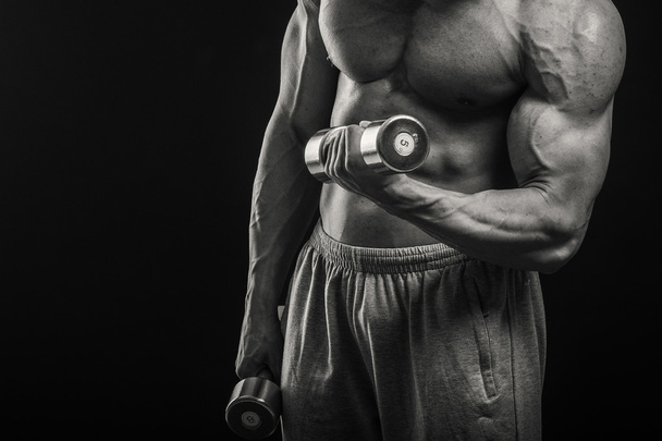 Bodybuilder shows his muscles - Φωτογραφία, εικόνα