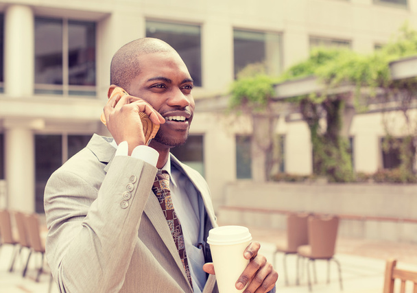 handsome happy businessman talking on mobile phone drinking coffee  - Foto, Bild