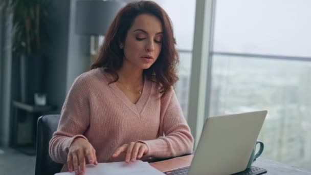 Serious employee talking laptop online in panoramic remote office closeup. Confident businesswoman explaining documents working on video call. Focused woman discussing project on team virtual meeting  - Footage, Video