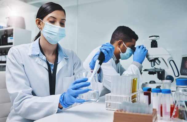 People, face mask and scientist or research team, medical laboratory and innovation or healthcare employee. Vaccine, pharmaceutical and chemical experiment, beaker and pipette for immunology study. - Photo, Image