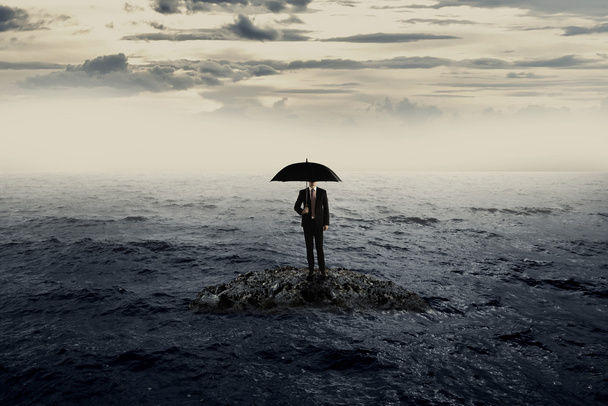 Man Holding Umbrella Stading On The Rock On The Sea - Фото, зображення