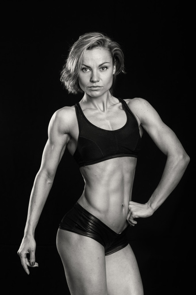 Woman shows her muscles - Φωτογραφία, εικόνα