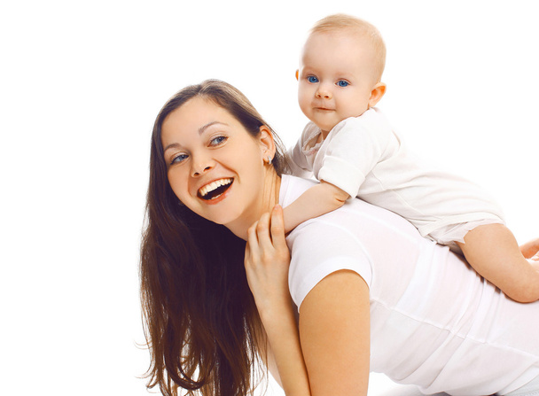 Laughing young mother playing with baby and having fun together - Фото, зображення