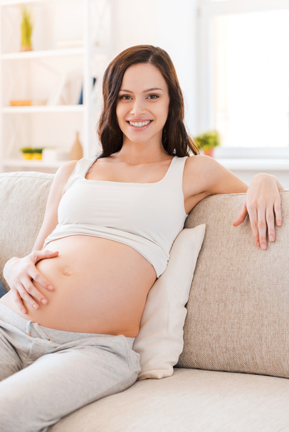 Pregnant woman touching her belly - Фото, зображення