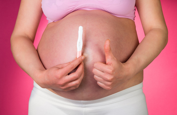 Pregnant woman with pregnancy test - Foto, Imagen