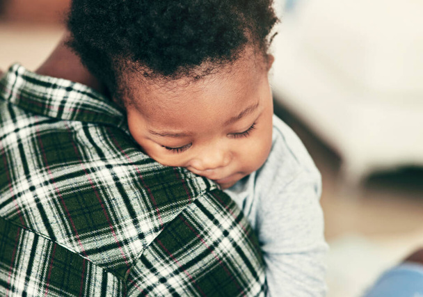 Mother, baby and sleeping in closeup on shoulder for security, love and peace in bedroom. Black woman, child and tired with relax for wellness in home, care or together for development with newborn. - Photo, Image