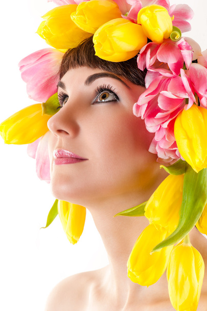 Beautiful woman with tulips on the head - Photo, Image