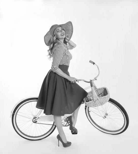 Girl with a bicycle in a retro style - Zdjęcie, obraz