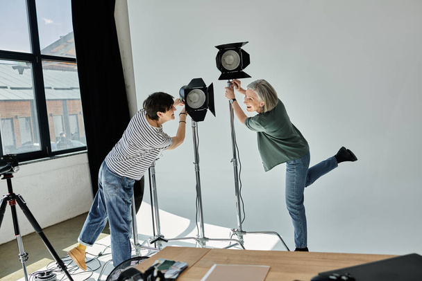 Middle-aged man and woman pose in a professional photo studio. - Photo, Image