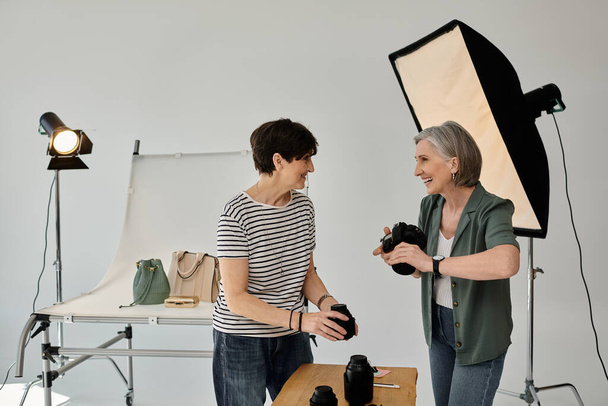 lgbt couple in a professional photo studio, working together with a camera. - Photo, Image