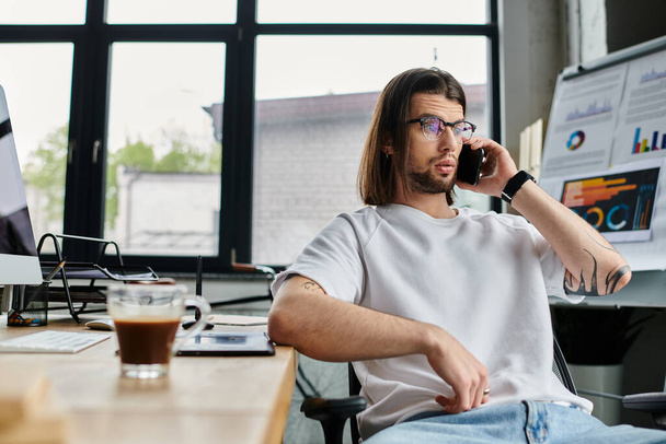 Caucasian businessman engrossed in phone conversation at desk. - Photo, Image