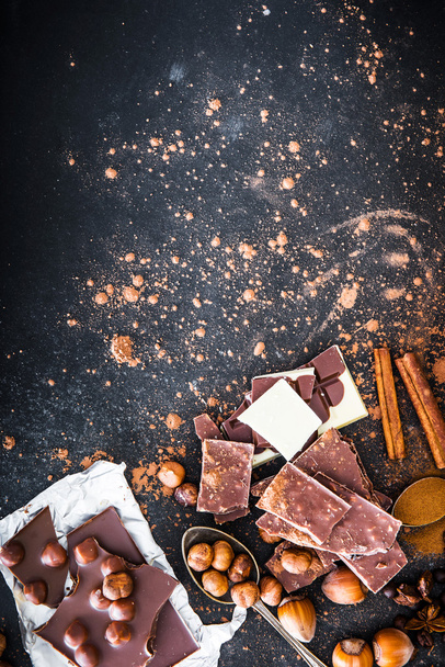 Chocolat and spices on black table - Foto, Imagen
