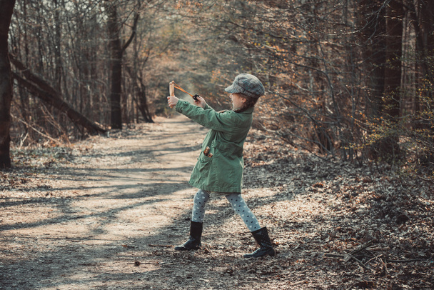 little girl playing with a slingshot - Photo, Image