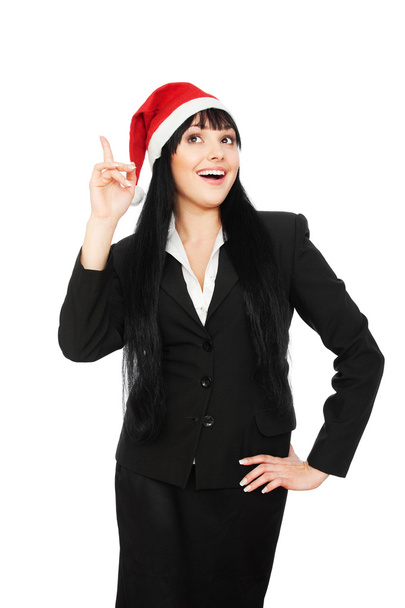 Felice donna d'affari in cappello di Babbo Natale che punta su
 - Foto, immagini