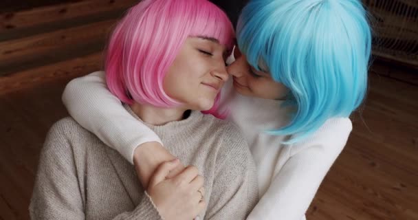 Couple, lgbt and lesbian women at home. Embrace and holding each other. Love and kiss, Pride Event, friendship concept. Romance and portrait of lesbian couple with blue and pink hair enjoying. - Footage, Video