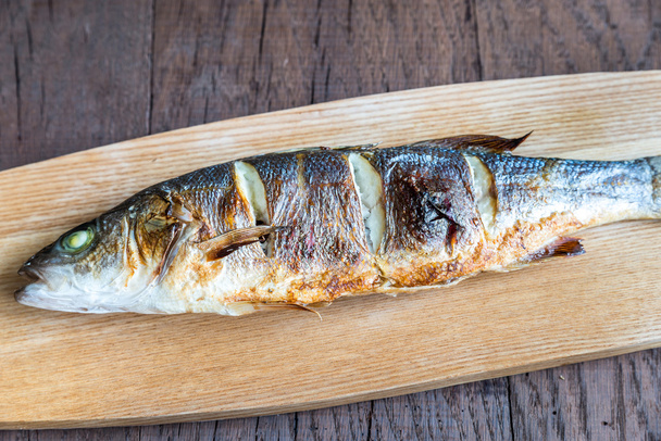 Grilled seabass on the wooden board - Photo, Image