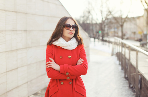 Portrait of beautiful woman in sunglasses and red jacket outdoor - Fotografie, Obrázek