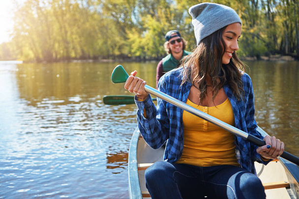 Couple, canoe and lake or forest holiday exploring or rowing outdoor, environment or journey. Man, woman and happy or travel weekend or river morning at vacation resort in Colorado, calm or island. - 写真・画像