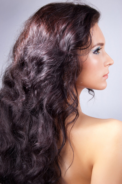 Young woman with long curly hair - Fotoğraf, Görsel