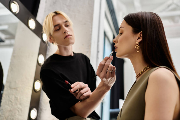 Handsome lgbtq makeup artist enhances womans natural beauty. - Photo, Image