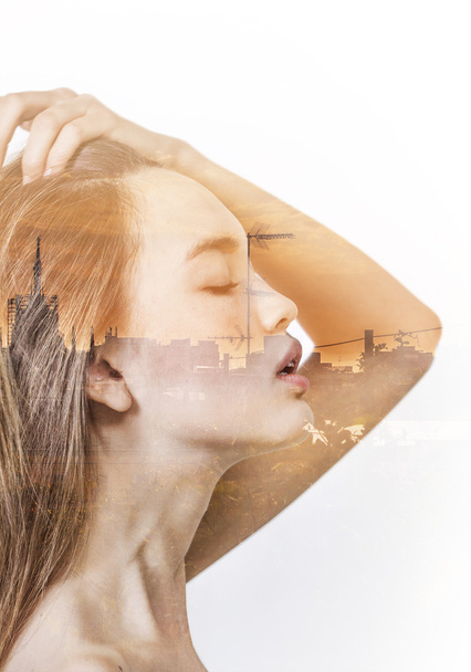 Double exposure of beautiful girl profile and sunset cityscape - 写真・画像