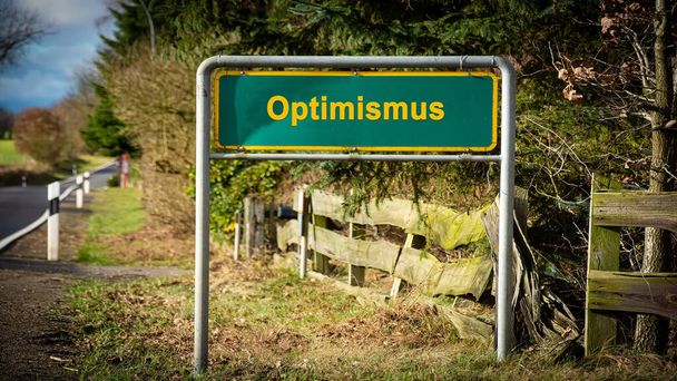 Wizerunek drogowskazu w języku niemieckim wskazujący kierunek optymizmu. - Zdjęcie, obraz