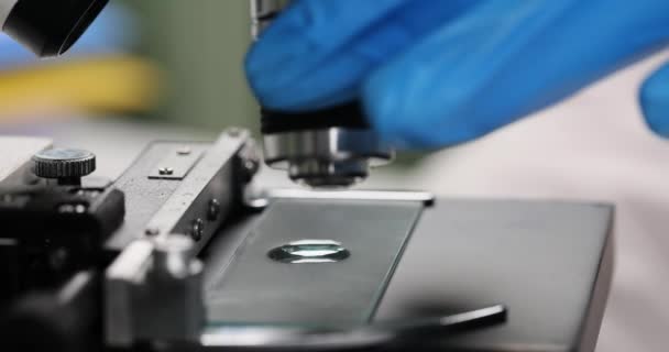 Wetenschapper druppelt vloeistof op microscopisch glas voor de test. Werken met chemicaliën in chemie lab - Video
