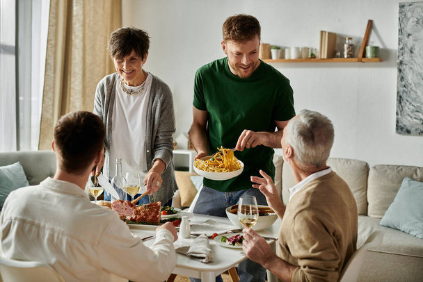 Um casal gay compartilha uma refeição com os pais em casa. - Foto, Imagem