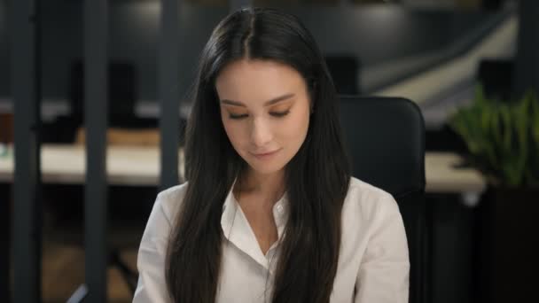 Caucasian businesswoman working in office looking at camera smiling sitting at company corporate workplace smile toothy business woman employer girl female secretary manager positive joyful portrait - Footage, Video