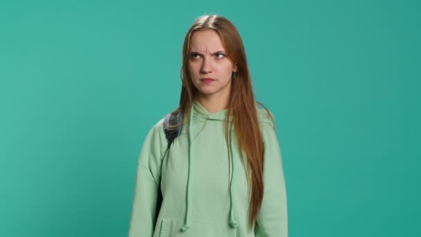 Young actress goofing around, switching emotions, trying different facial expressions, practicing for theatre class, studio background. Teenage woman making silly faces, camera A - Filmmaterial, Video