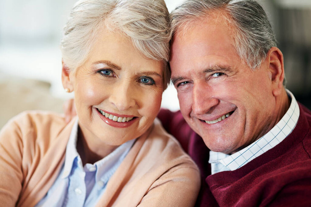 Happy, senior couple and hug in portrait for affection, support and commitment to marriage and relationship. Mature, woman and man with smile and love embrace for bonding and retirement at home. - Photo, Image