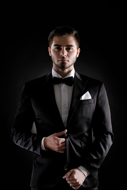 Elegant man in suit on dark background - Foto, Imagem