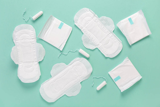 Menstrual pads with tampons on turquoise background - Photo, Image
