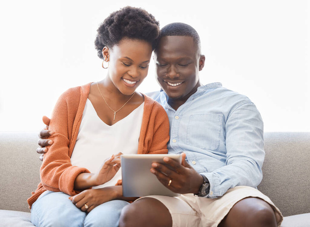 App, social media και tablet με μαύρο ζευγάρι στον καναπέ στο σαλόνι του σπιτιού για περιήγηση μαζί. Αγάπη, χαμόγελο ή τεχνολογία με ευτυχισμένο άνδρα και γυναίκα στο διαμέρισμα για streaming βίντεο στο διαδίκτυο. - Φωτογραφία, εικόνα