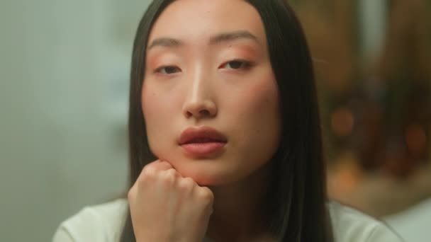 Sad lonely frustrated upset Asian Korean woman girl student businesswoman stressed tired Chinese Japanese female headache bad health problem worried suffer depression displeased close up face emotions - Materiał filmowy, wideo