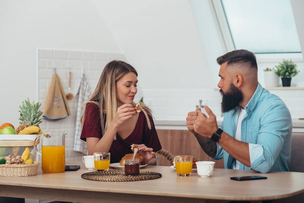 Schnappschuss eines Ehepaares beim Frühstück in der Küche - Foto, Bild