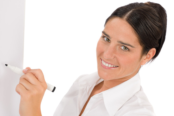 Happy businesswoman writing at empty flip chart - Foto, imagen