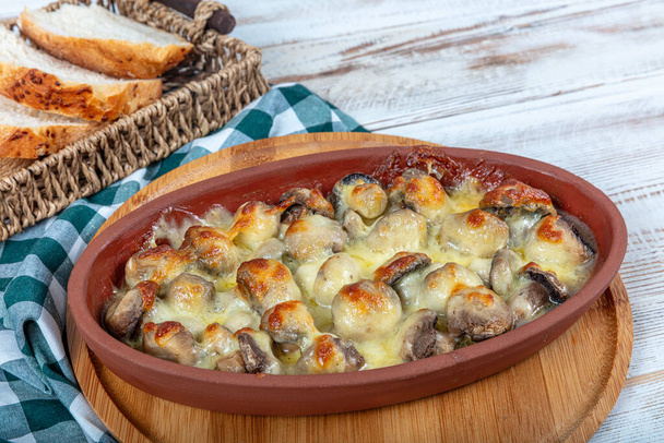 Mushroom with melted cheese in casserole stew. Mushroom casserole covered with melted cheese. Mushroom gratin. Turkish name; Mantar Graten, Peynirli mantar. - Photo, Image