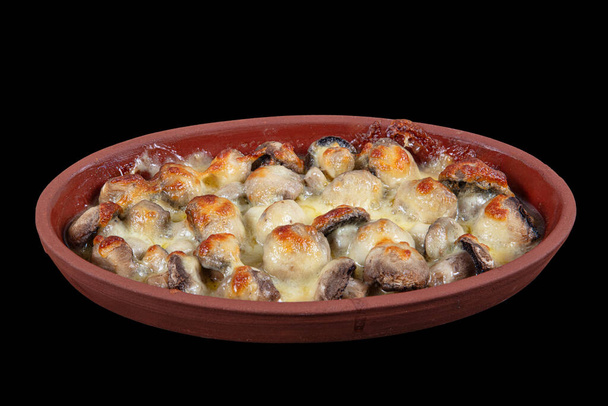 Mushroom with melted cheese in casserole stew. Mushroom casserole covered with melted cheese. Mushroom gratin. Turkish name; Mantar Graten, Peynirli mantar. Decoupage on black background. - Photo, Image