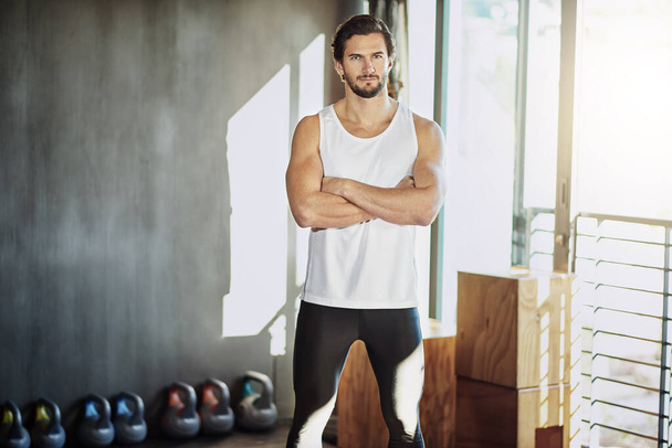Crossed arms, fitness and portrait of man in gym for intense training, exercise and cardio workout. Sports, personal trainer and serious person for wellness, healthy body and performance with muscles. - Photo, Image