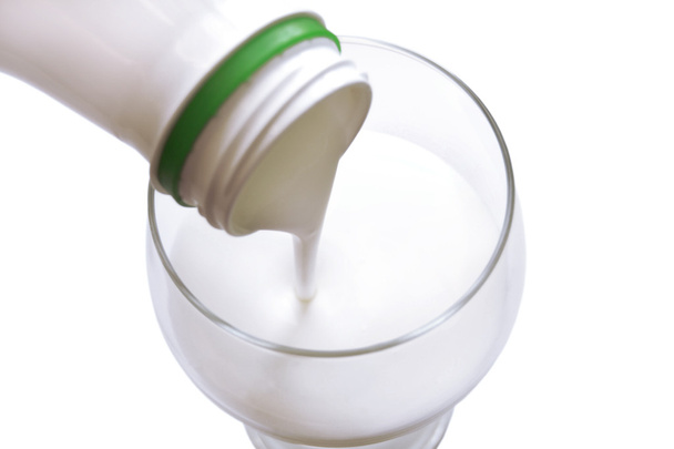 The white yogurt gets into from bottle in glass - Zdjęcie, obraz