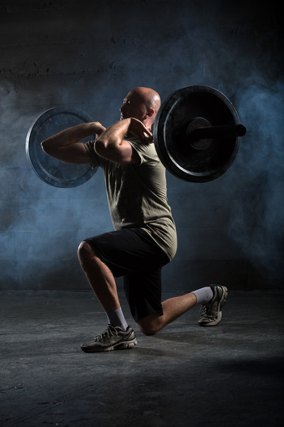Bald athlete doing exercise with a barbell - Photo, Image