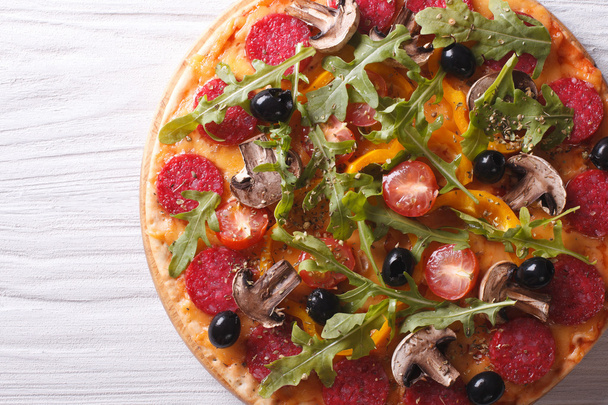 pizza with rocket salad and salami, horizontal top view  - Photo, Image