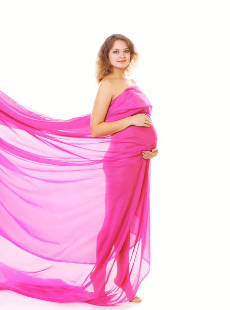 Beautiful pregnant young woman with flying bright cloth  - Foto, afbeelding
