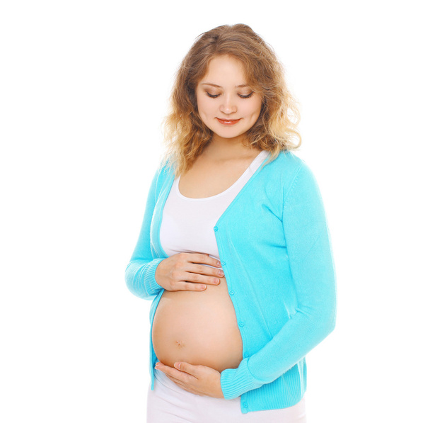 Happy pregnant young woman on a white background - Foto, imagen
