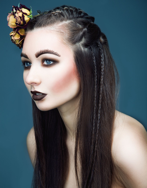 art portrain of brunette woman with roses in hairs. Creative got - Foto, afbeelding