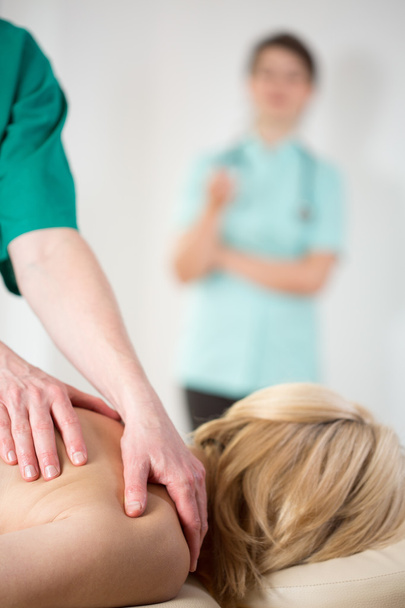 Doctor observing masseur - Photo, image